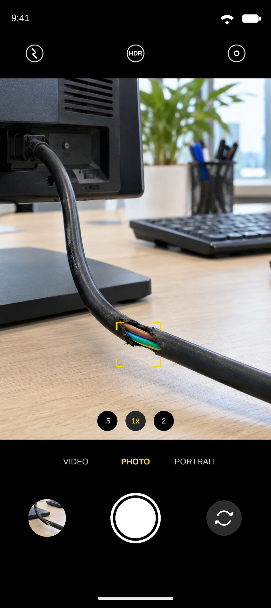 The phone's camera open on the damaged lead, ready to take the photo that goes with the test.